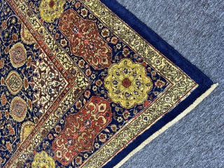 A Tabriz carpet with an 'Ardabil Carpet' medallion design, set against a blue foundation and complemented by red and yellow patterns on blue borders, often represents a beautiful and intricate piece of  ...