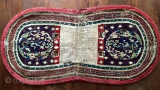 Early Tibetan saddle rug, aubergine ground and amazing Tang style medallions.                      