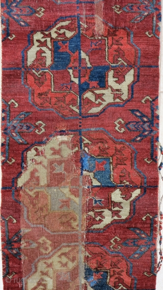 old Tekke Turkmen main carpet fragment from an early or mid century piece. A vertical strip with 10 guls representing the full vertical height of the field.  Several old and strange  ...