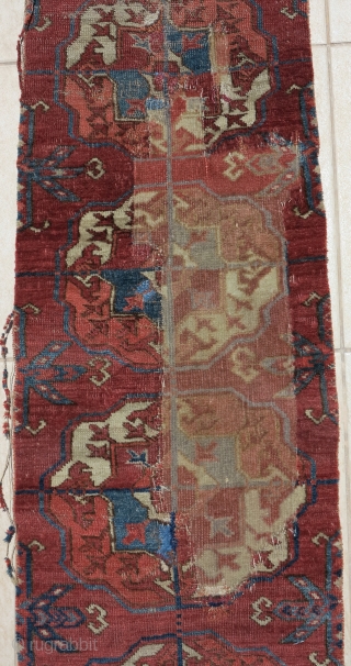 old Tekke Turkmen main carpet fragment from an early or mid century piece. A vertical strip with 10 guls representing the full vertical height of the field.  Several old and strange  ...