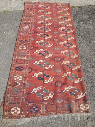 An antique Tekke main carpet  . 220/200 cm. Very old and Fine. Some repairs. Original size.                