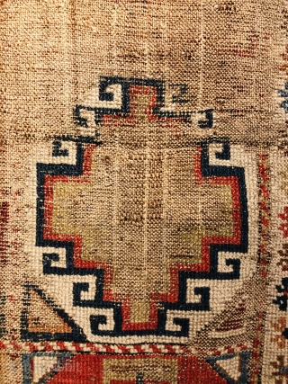 Early Caucasian (140x95 cms)Small perfectly worn out complete rug it also has brindled (camel?) warps and a very interesting Memling gul.            