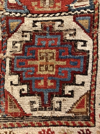 Early Caucasian (140x95 cms)Small perfectly worn out complete rug it also has brindled (camel?) warps and a very interesting Memling gul.            