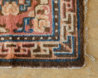 Antique Tibetan Rug. This is a chair cover designed with 3-d maze elements exuding some Chinese influence.

width: 2'0"
length: 2'0"
dominant colors: Salmon & Blue          