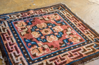 Antique Tibetan Rug. This is a chair cover designed with 3-d maze elements exuding some Chinese influence.

width: 2'0"
length: 2'0"
dominant colors: Salmon & Blue          