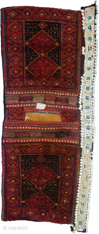 Charming antique Kurdish Saddlebag from the West of Iran.  The lustrous soft wool has been dyed using natural dyes and all the locks are intact. The button and shell decoration with  ...