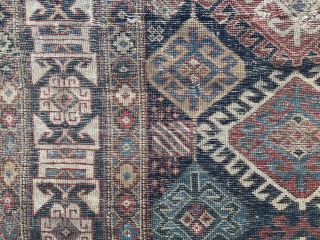 About half of an old Kuba rug on blue ground with a forest green back or fore forest green ground Kufic border.           