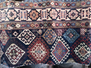 About half of an old Kuba rug on blue ground with a forest green back or fore forest green ground Kufic border.           