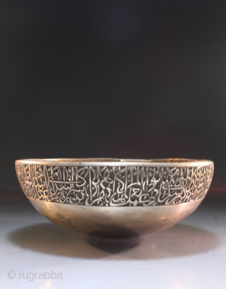 A Mughal Deccan bronze calligraphic bowl, India, Golconda or Bidar, 16th century of squat round bowl form, an engraved Arabic calligraphic around the bowl, the spherical base encircled by a splayed ridge,  ...