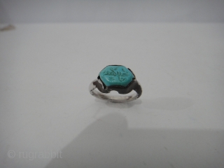 A Seljuk turquoise-set Silver Ring. Persia, 12th-13th Century. 

the bazel engraved with arabesques kufic words engraved name .

Condition Report : Extremly fine cleaned          