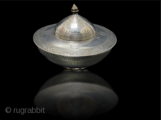 A Persian - Arabic beautiful silver sweet box engraved arabic & persian words . Date 19th Century mentioned around rim of the box in arabic .



       