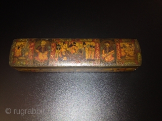 A POLYCHROME LACQUER PAPIER MÂCHÉ PEN CASE (QALAMDAN) QAJAR IRAN, 19TH CENTURY
With rounded ends and sliding tray, the top painted with a central cartouche depicting Nasir al-Din Shah with Persian poems enthroned  ...