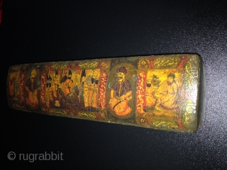 A POLYCHROME LACQUER PAPIER MÂCHÉ PEN CASE (QALAMDAN) QAJAR IRAN, 19TH CENTURY
With rounded ends and sliding tray, the top painted with a central cartouche depicting Nasir al-Din Shah with Persian poems enthroned  ...