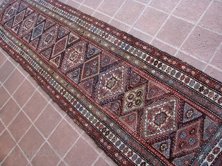 Antique 2' 10" x 13' 10" Kurd.  Lays straight; In low to medium pile condition, with the original end webbings having been sewn underneath. Two very small replied areas on one  ...