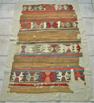 Central Anatolian Banded Kelim Fragment / Natural Camel Stripes
Circa 1800 / possibly earlier? Mounted on beige linen.
Size: 1.45 x .97m.  The kelim has a beautiful deep old rose color,
and the best  ...