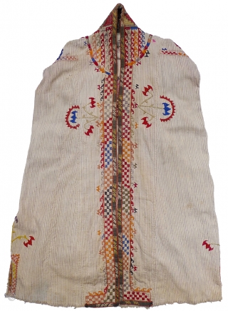 Woman's Jelak. South Uzbekistan, second quarter 20th century. Silk hand-embroidery on handwoven cotton with narrow stripes. Unlined. Silk woven and embroidered trim applied along edge; silk fringe; three pearl buttons. 35" length  ...