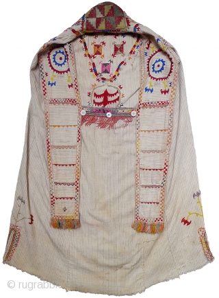 Woman's Jelak. South Uzbekistan, second quarter 20th century. Silk hand-embroidery on handwoven cotton with narrow stripes. Unlined. Silk woven and embroidered trim applied along edge; silk fringe; three pearl buttons. 35" length  ...