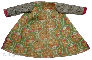 Uzbek Brocaded Boy's Robe. Russian silk brocade with gold and silver metallic threads. Russian Art Nouveau printed-cotton lining. Good condition except for some wear to the metallic threads; fading to the center  ...