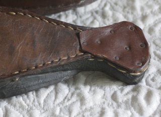 Misc 175 
This antique pair of Hand made leather are the old traditional shoes which were worn in Turkey. They were called Charoog...spelling may vary. The soles are concave and curl to  ...