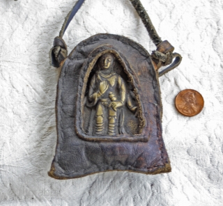 Antique Tibetan Bronze Talisman in leather case.

This antique Tibetan talisman depicts a  bronze Buddha which is also displayed in a hand sewn leather casing. The Buddha is depicted as holding a  ...