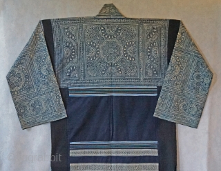 Vintage Chinese Miao Ethnic Minority long jacket...  
intricate batik using indigo dye...all hand sewn...
hand woven ribbon strips decorate the lower back... 
easy to wear, field tested by me...
looks great hanging on  ...