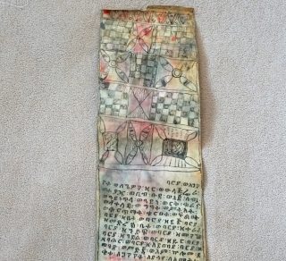 This is a traditional Antique Coptic Christian scroll from the Oromo people of Ethiopia. Painted on Vellum (processed animal skin) and using a special black and red ink, the text is in  ...
