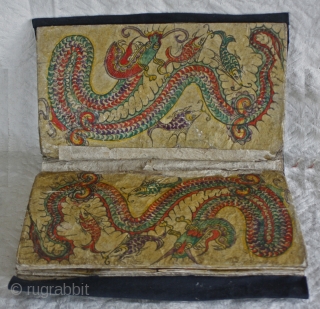 EMT159    Dong Ethnic Minority textile wallet  
This wallet would have been used to keep sewing supplies Each page is made from heavy hand paper, hand painted decoration and  ...