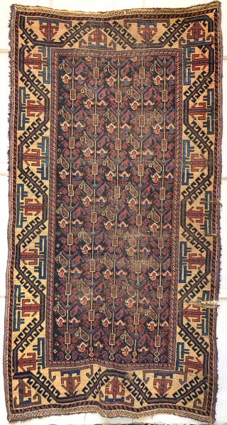 Antique 'Arab' Baluch rug, 3'4 x 6'4. Dramatic blue-black ground in field with design of vertical 'botheh' trees. Camel ground border. Natural dues with nice red and polychromatic blue. Machine selvedge added,  ...