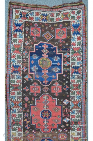 Caucasian long rug 317 x 104 cm, great colors including tomato red, aubergine and one camel ground medallion, archaic patterns.             