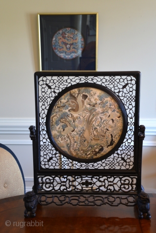 1850 Chinese table screen silk embroidery panel mounted in carved hardwood frame. The panel is densely embroidered with various birds, including an eagle and two peacocks in the foreground, with pine trees,  ...