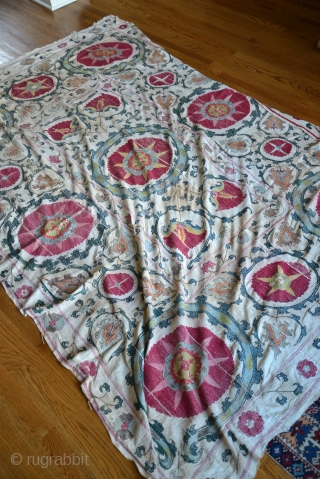 19th Century Uzbek Bukhara Suzani made of 8 almost equal panels stitched together vertically. Very good condition with very minor fraying and light stains. All natural colors include apricot, magenta, red, several  ...