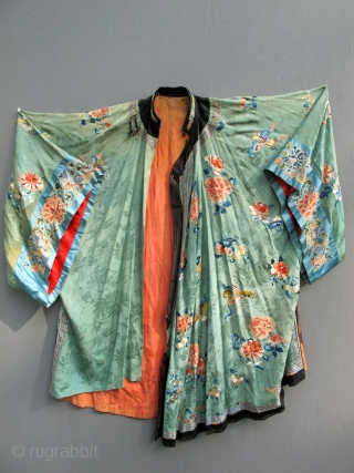 A finely embroidered XIXth C. Chinese green silk robe.                        