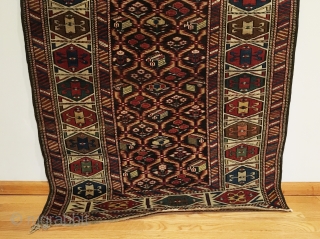 Daghestan Runner.  Circa 1850.  Stunning Caucasian runner exhibiting curvature to field design and unequal minor borders: a hallmark of tribal weaving. Daghestan border.   Some field motifs appearing three  ...