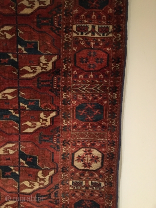 Tekke Main Carpet.  1st Half 19th Century.   Spacious red-purple field displays large rounded Tekke guls and secondary Gurbaghe guls connected by a fine line.  Cruciform star end borders  ...