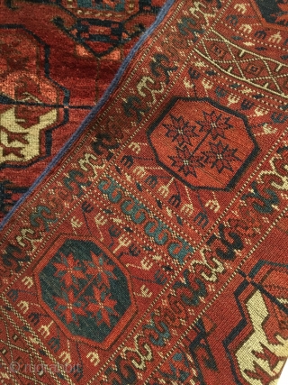 Tekke Main Carpet.  1st Half 19th Century.   Spacious red-purple field displays large rounded Tekke guls and secondary Gurbaghe guls connected by a fine line.  Cruciform star end borders  ...