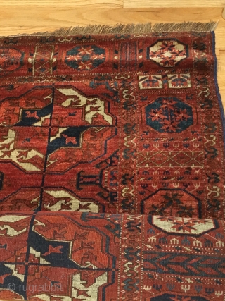 Tekke Main Carpet.  1st Half 19th Century.   Spacious red-purple field displays large rounded Tekke guls and secondary Gurbaghe guls connected by a fine line.  Cruciform star end borders  ...