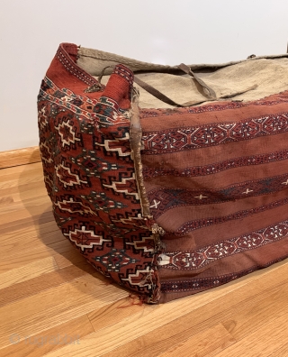 Antique Yomud Chuval. 19th Century. It is rare to find complete storage bags as many have been dismembered due to harsh conditions of seasonal migration. Sides feature a stepped hooked gul. Rear  ...