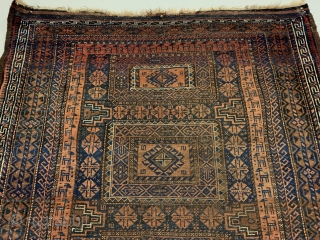 Antique Maadan Baluch Long Rug. Northeast Persia, Khorasan. This finely woven brown field offers a captivating inner border of rams. The central tribal design patterns are seen enclosed by 9 intricate borders.  ...