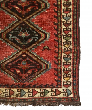Antique Persian Veramin Rug. Late 19th Century. This piece features a repeating diamond pattern enclosing alternating shrub flowers on a saturated cherry red field. Featuring a central row of multi-colored secondary motifs.  ...