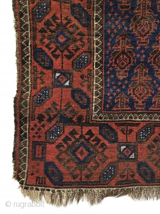 Antique Baluch Rug. North East Persia. Mid 19th Century. Deep blue field covered with Dokhtar-I-Ghazi bird trees. A main border of intermittent octagons enclosing bird head diamonds, associated with earlier rugs. Great  ...