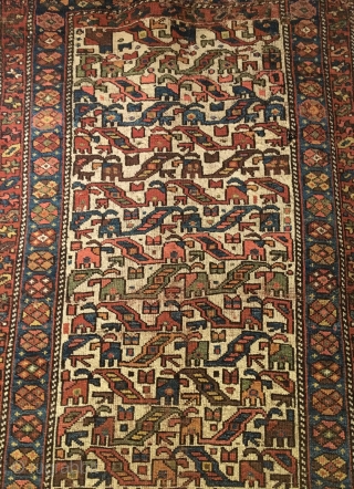 Antique Kurdish Long Rug. Last Quarter 19th Century. 21 Colorful Rows of archaic dragon motifs. Some pile loss to top left. Old darning visible across bottom. Original braided top and selvage. 3’11  ...