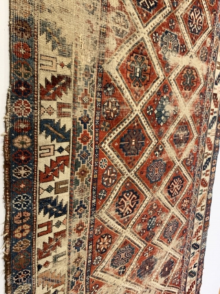 Antique Caucasian Small Rug. Circa Early. Two columns of ivory diamond lattice with alternating rows of gols. Leaf and wine glass border. Remnants of embroidered macrame ends on top. Original condition with  ...