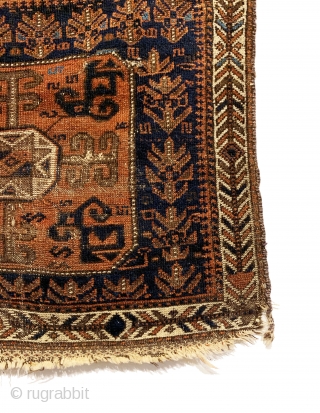 Antique Baluch Bagface. Northeast Persia. 2nd Half 19th Century. Shrubs and S design on blue field surround Tukoman like Gol with quartered dragon elements. Interesting white ground border. Original condition. Nice wall  ...