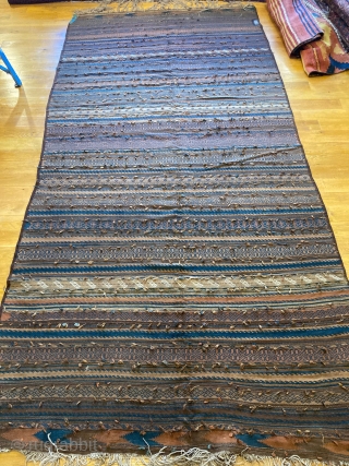 10'9" x 5'9" Rare Baluch Dowry Kilim [020]

Rare dowry kilim. This piece features intimate rows with various weft floats and tribal motifs. Wool and silk tufts embroidered into the weft called “wishes”.  ...