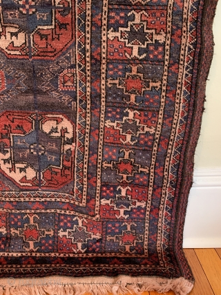 Turkmen Main Carpet. Circa Antique. Afghanistan. The ‘aina gochak’ main border frames a 4x7 gul layout of varying size on a rare purple ground. An interesting ‘gurbaghe’ secondary gul. Radiating bird heads.  ...