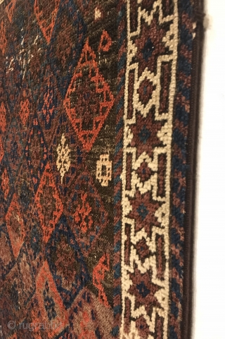 Antique Small Baluch Rug. 4th Quarter 19th Century. Northeast Persia. Rows of diamonds enclose a stepped cross containing birds head motifs. The white ground star border encloses a colorful and lively field  ...