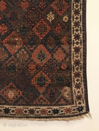 Antique Small Baluch Rug. 4th Quarter 19th Century. Northeast Persia. Rows of diamonds enclose a stepped cross containing birds head motifs. The white ground star border encloses a colorful and lively field  ...