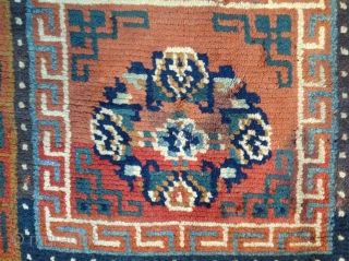 Sitting Carpet.
Archaic composition with bold border structure.
Goat hair foundation. Vegetal dyed wool pile.
32 x 32 inches
Village weaving
19th century
TIbet

* conditions: some minor discoloration. Requires minor restoration....Broken selvedge (visible on lower left side).two broken  ...