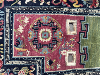 Makden (under saddle rug), South Central Tibet, probably around 1900, 128 x 64 cm, the main field was likely dyed with Indian lac, the central border consists the Eight Taoist Symbols of  ...