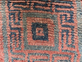 Quite rare and powerful monastic Tibetan seat rug with a square central symbol that shrinks in five steps to the centre. A running dog variant as a border. I would date the  ...